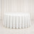 White round table with textured linen tablecloth in elegant neutral room