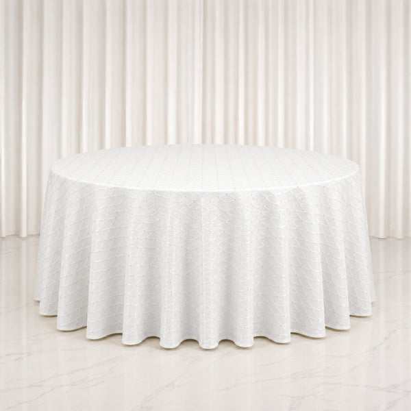White round table with textured linen tablecloth in elegant neutral room