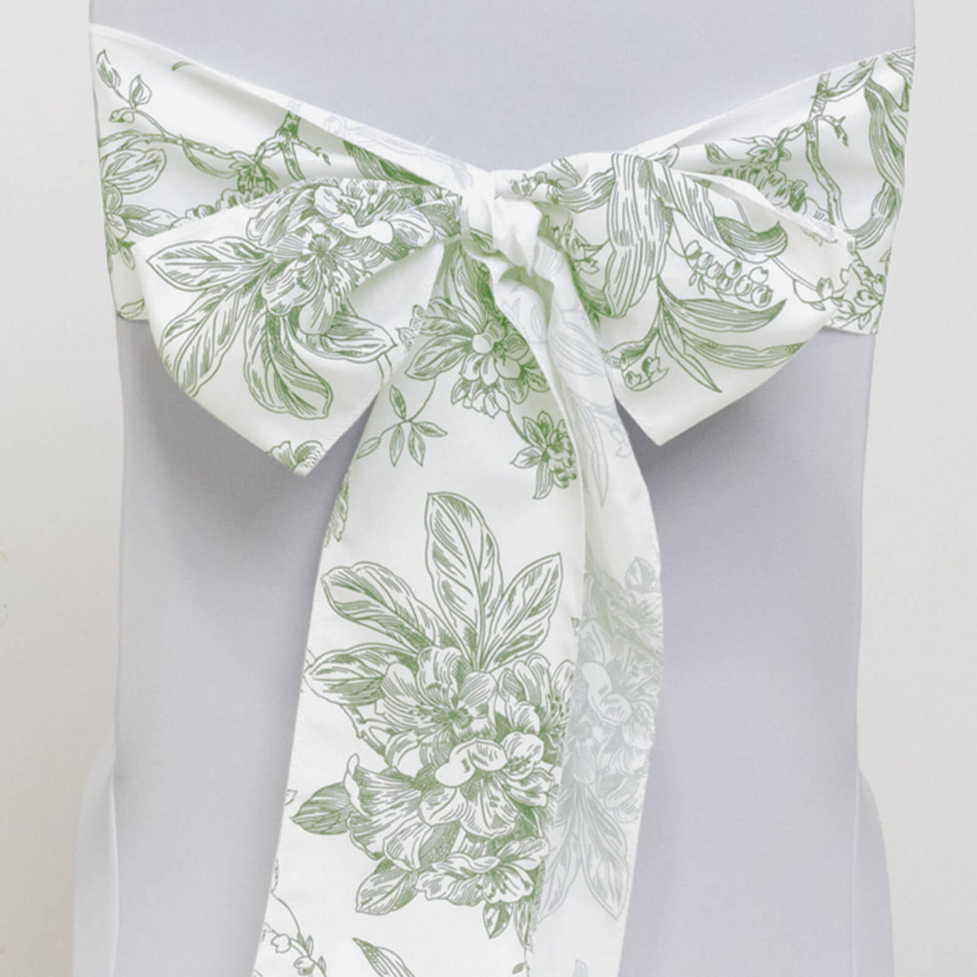 Floral-patterned chair sash in green and white with a bow.