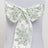 Floral-patterned chair sash in green and white with a bow.