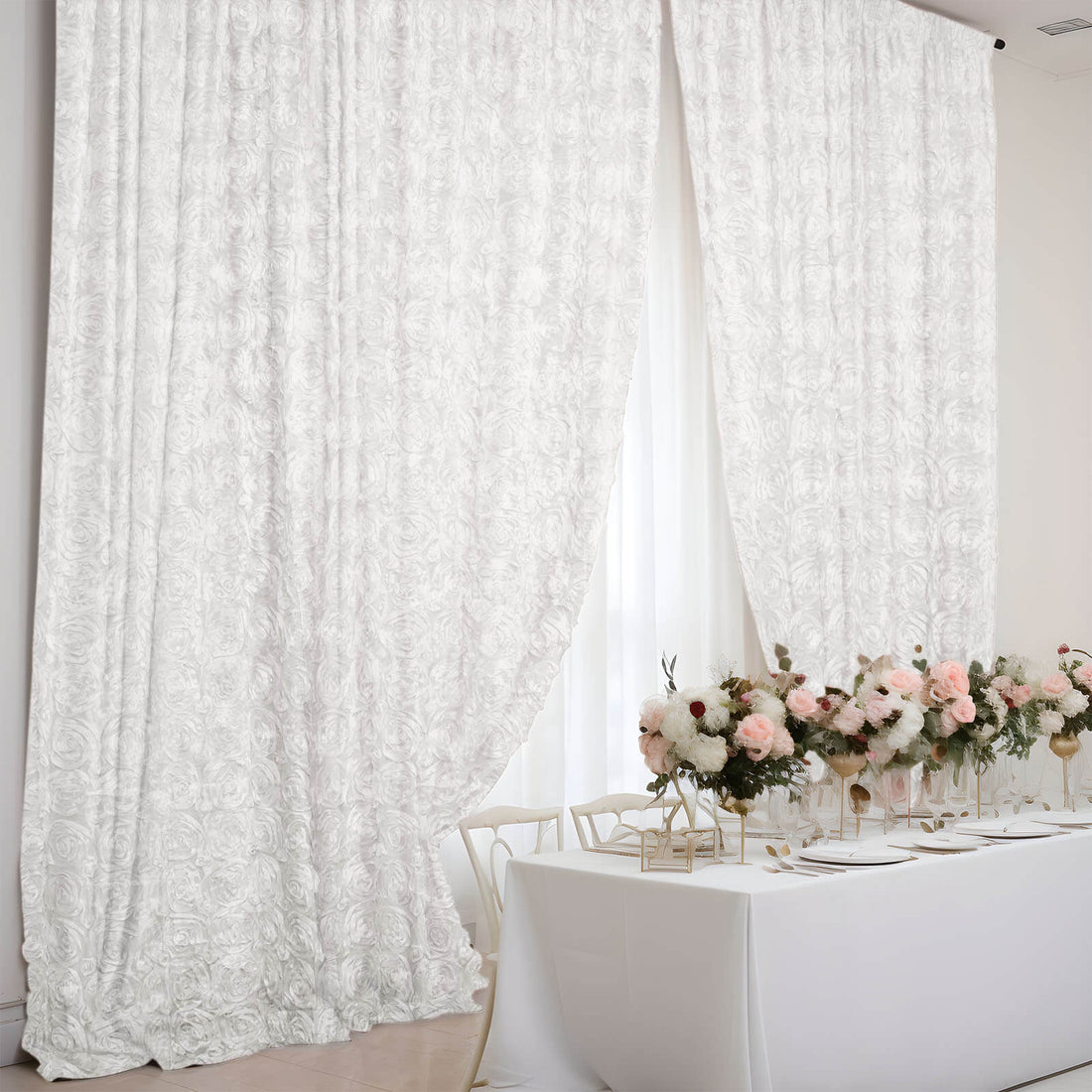 Elegant white floral curtains draping over a beautifully set dining table.