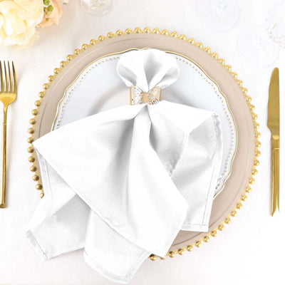 Elegant white napkin on a decorative plate with gold accents.