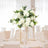 Elegant white floral centerpiece in a modern dining setting.