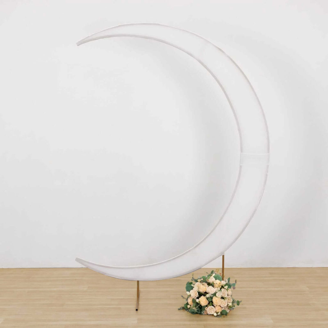 White crescent moon backdrop with floral arrangement at the base