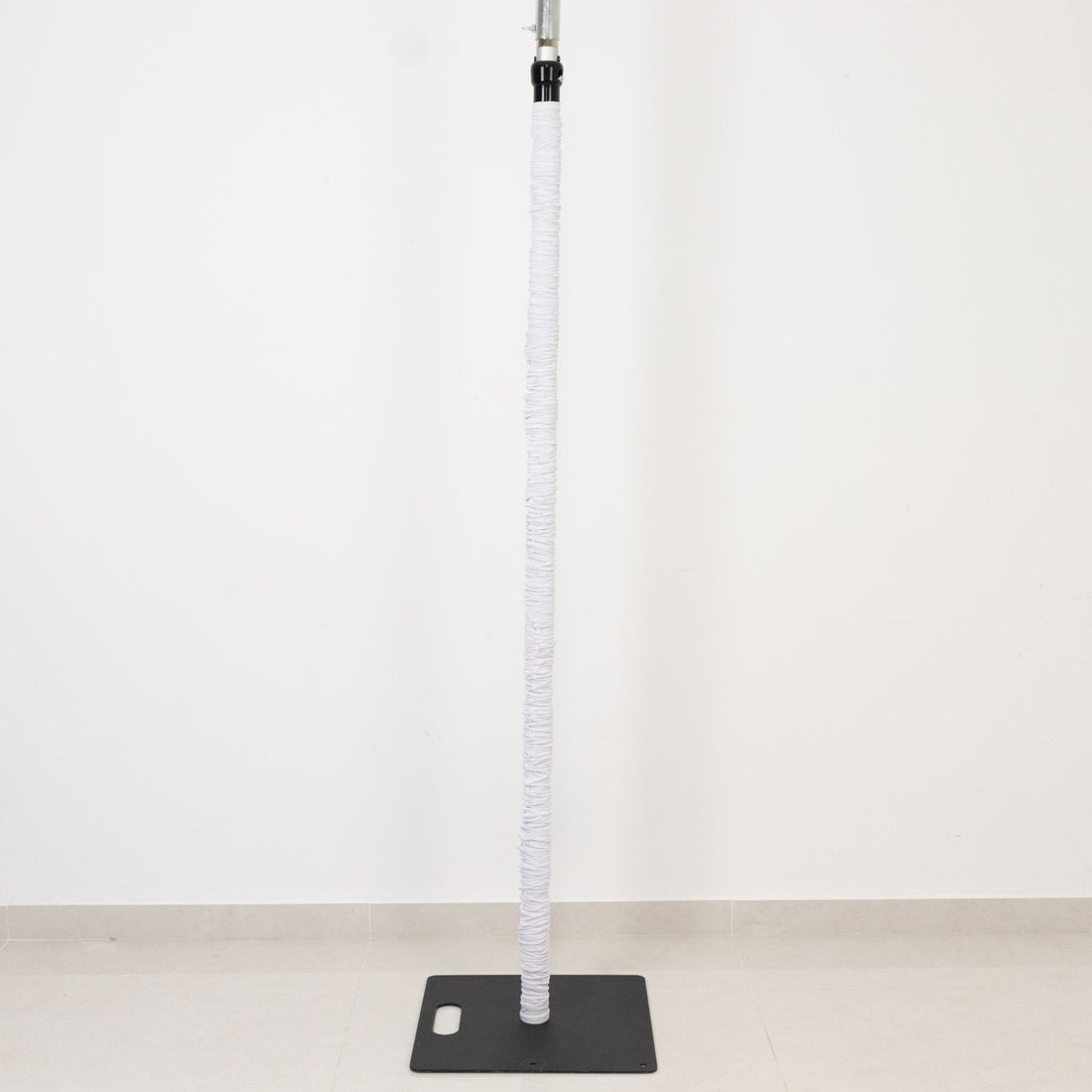 White pole with black base, wrapped in soft material for comfort and grip.