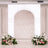 Elegant wedding arch with floral arrangements on either side.