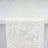 White textured fabric runner with subtle abstract pattern on a table