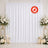White wedding backdrop with floral arrangements and candles, flame retardant