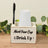 Wooden cup holder with "Mark Your Cup & Drink Up!" text and a pen.