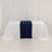 White table with a navy blue runner in a studio setting.