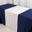 Navy and white table runner draped over a table for elegant decoration.