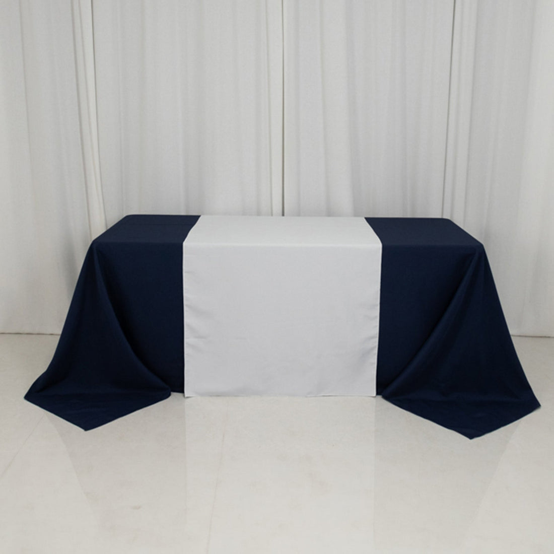 Navy and white tablecloth draped over a table in a studio setting