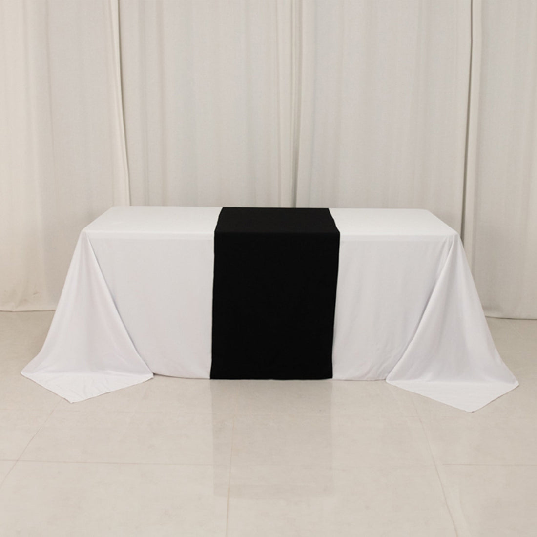 Table with white and black tablecloths for events and gatherings