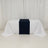 Navy table runner on white tablecloth in a minimalist setting