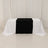 Black and white tablecloth draped over a table in studio setting