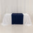 Navy table runner on a white table with draped white fabric