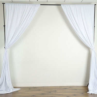 White backdrop with draped fabric for photography or events.