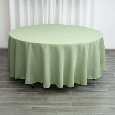 Round green tablecloth draped elegantly over a table.