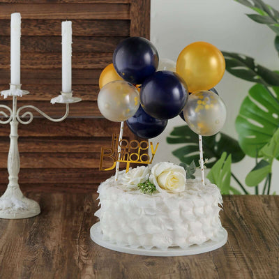 Birthday cake with balloons and floral decoration on a wooden table.