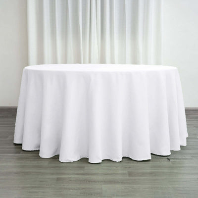 White tablecloth draped over round table in a bright setting.