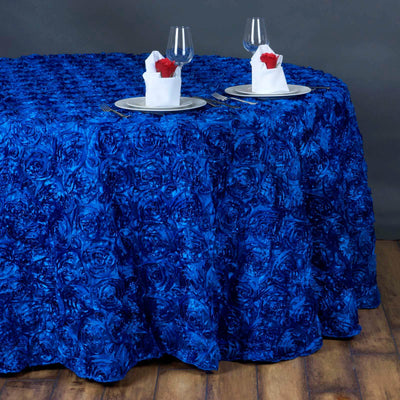 Blue rose-patterned tablecloth draped over a round table set for dining.