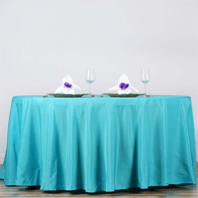 Turquoise tablecloth with elegant table setting and glasses
