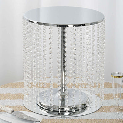 Crystal beaded accent table with a chrome base and reflective top.