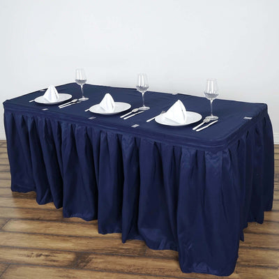 Navy tablecloth draped over a table set with plates and glasses.