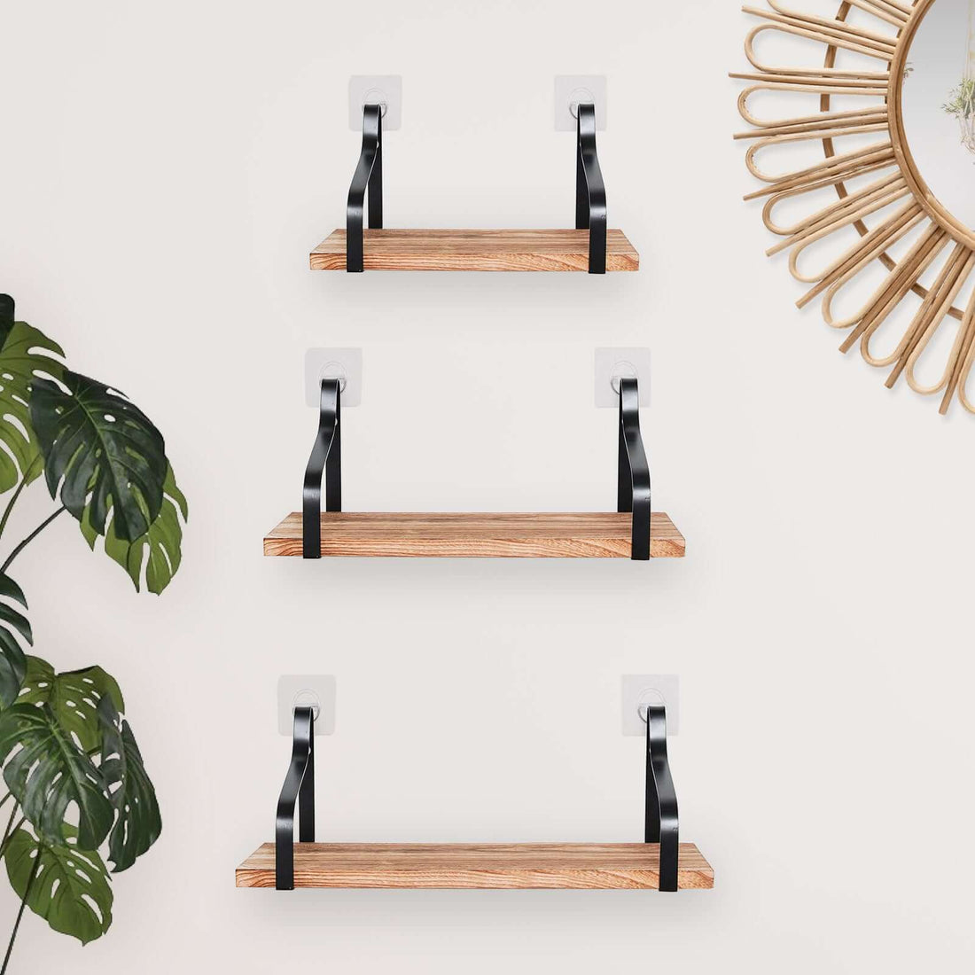 Wooden floating shelves with black brackets against a light wall.