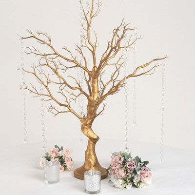 Gold decorative tree with hanging crystals and floral arrangements.