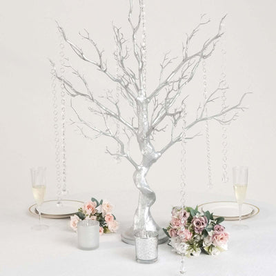 Elegant silver tree centerpiece with hanging crystals and floral arrangements.