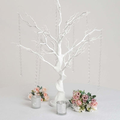 White decorative tree with hanging crystals and floral arrangements