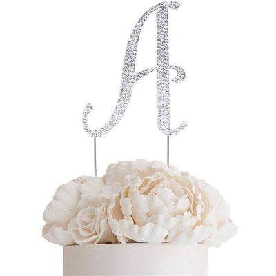 Silver glitter letter "A" cake topper with white floral accents.