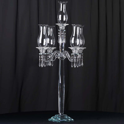 Elegant crystal candelabra with three glass shades and decorative accents.
