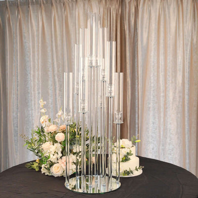 Elegant glass candle holder centerpiece with floral arrangement.