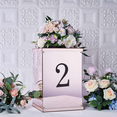 Rose gold table number holder with floral arrangement and number 2.