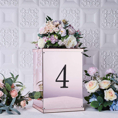 Elegant floral arrangement in mirrored box with number 4 on a textured background.