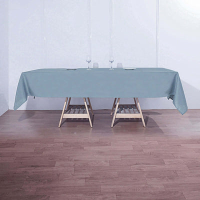 Elegant light blue tablecloth draped over a wooden table.