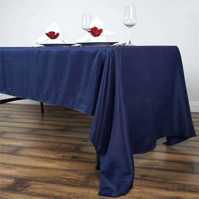 Navy blue tablecloth draped elegantly on a table with decorative plates and glasses.