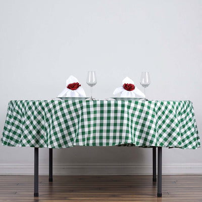 Green and white checkered tablecloth with elegant napkin folds and glasses.