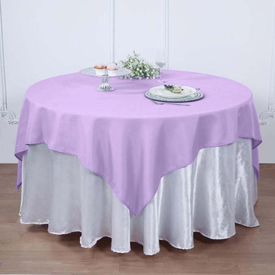 Lavender round tablecloth draped over a silver table skirt.