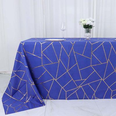 Blue geometric tablecloth with gold accents on a white background.