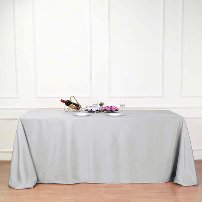 Elegant gray tablecloth draped over a table with wine and flowers