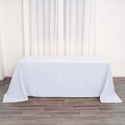 Plain white tablecloth draped over a table in a well-lit room