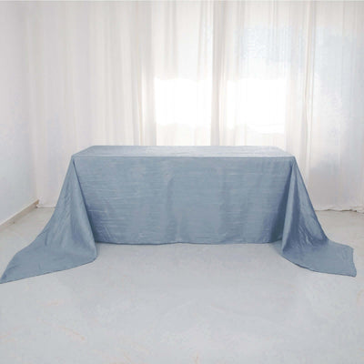 Blue tablecloth draped over a table in a bright, airy setting.