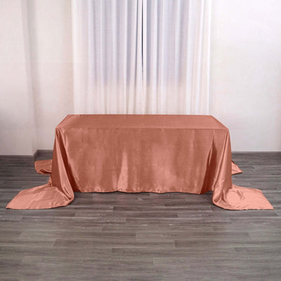 Peach satin tablecloth draping elegantly over a table