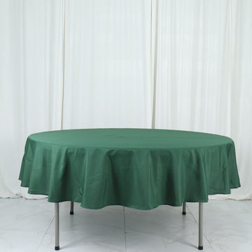 Create a Chic and Festive Setting with the Hunter Emerald Green Seamless Polyester Round Tablecloth 90"