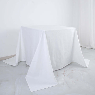 White tablecloth draped over a table in a minimalist setting.