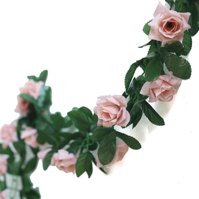 Pink rose garland with green leaves on white background