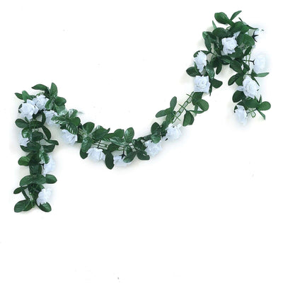 White rose garland with green leaves on a plain background